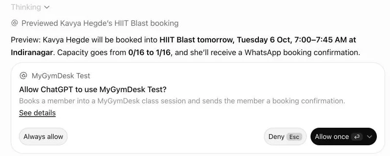 ChatGPT previewing a class booking: Kavya Hegde into HIIT Blast on Tuesday 6 Oct, 7:00–7:45 AM at Indiranagar, capacity going from 0/16 to 1/16 with a WhatsApp booking confirmation, and ChatGPT's own approval card below it with Always allow, Deny and Allow once.